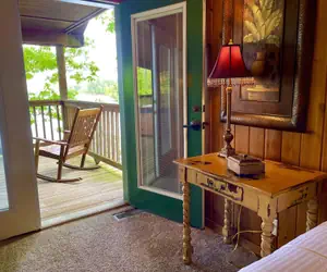 Photo 2 - Lake view three bedroom, three bath log-sided cottage with private hot tub overlooking Lake Ouachita. by RedAwning