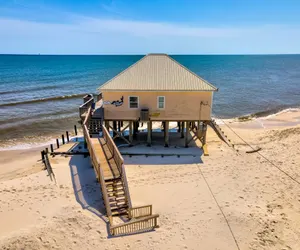 Photo 2 - Villa Delphinus - Beachfront! and Pet Friendly!  Feel the ocean breezed and hear the waves lapping right at your doorstep!