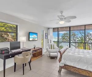 Photo 3 - Beautiful End Unit with water views from all windows overlooks the Bay and Tropical Beach Setting