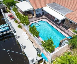 Photo 3 - Luxe 4BR Waterfront w Htd Pool 5min to Beach