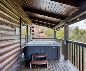 Photo 3 - Cozy Cabin Hot Tub Balcony Golf Simulator Near Pigeon Forge Smoky Mountain Group Retreat Mountains Are Calling by Avantstay