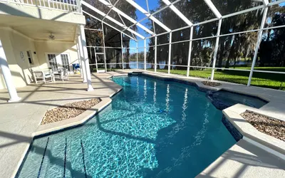 Stylish Lakefront Cottage w/Huge South Facing Pool Hot Tub BBQ - 2 miles Disney!