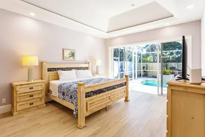 Photo 2 - Imola: Newly Remodeled Pool Home Minutes from Vanderbilt Beach. Family-Friendly Retreat with 4 BR, 3.5 Bathrooms, and Private Screened Pool. Perfect Location Near Mercato and Naples Attractions