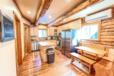 Photo 2 - Log cabin with fireplace, minutes from skiing, snowmobiling, xc ski, and more!