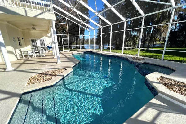 Photo 1 - Stylish Lakefront Cottage w/Huge South Facing Pool Hot Tub BBQ - 2 miles Disney!