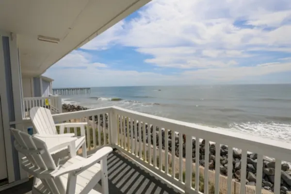 Photo 1 - Beach Sunrise - Relaxing and Romantic!  Enjoy ocean views from the bedroom with balcony access.