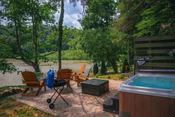 Photo 1 - Cozy Cabin on Lake Front With Hot tub Firepit